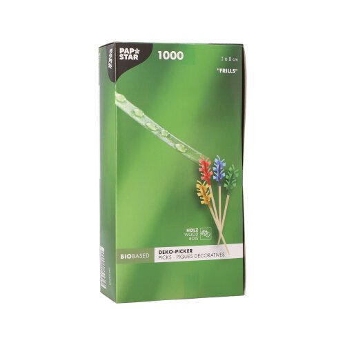 PAPSTAR 1000 dekorativní napichovátko 6,8 cm „Ruffles“ od PAPSTAR GmbH je dodáváno v zelené krabici s barevnými ozdobami pro stolní dekoraci a je zabaleno v obalu s vyobrazením napichovátek a kapky rosy na trávě v detailním záběru.