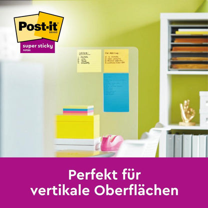 Přehledný dělič prostoru ukazuje Post-it® Z-Notes Dispenser XL, černý s velkými, linkovanými, žlutými Post-it® Super Sticky Z-Notes (101mm x 101mm) od 3M Deutschland GmbH v kanceláři. Německý text: "Perfektní pro vertikální povrchy.