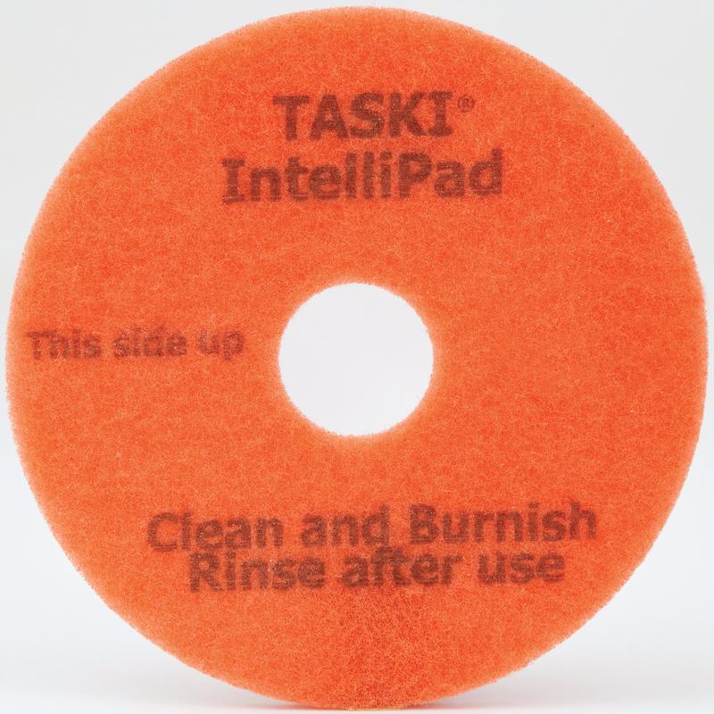 Das TASKI Intellipad Kombiniertes Reinigungs- und Polierpad für Unterhaltsreinigung von Diversey Deutschland GmbH & Co. OHG ist ein orangefarbenes, kreisförmiges Pad mit einem Loch in der Mitte und der Aufschrift "TASKI IntelliPad", "This side up" und "Clean and Burnish, Rinse after use" in grauer Schrift.