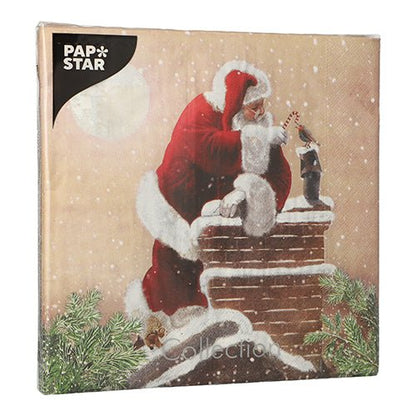 PAPSTAR 20 ubrousků, 40x40 cm, 3-vrstvé, s vánočním motivem: Santa Claus strká cukrovou hůlku do ponožky na zasněženém komíně, větve jedle a měsíc v pozadí. Branding PAPSTAR GmbH nahoře vlevo.