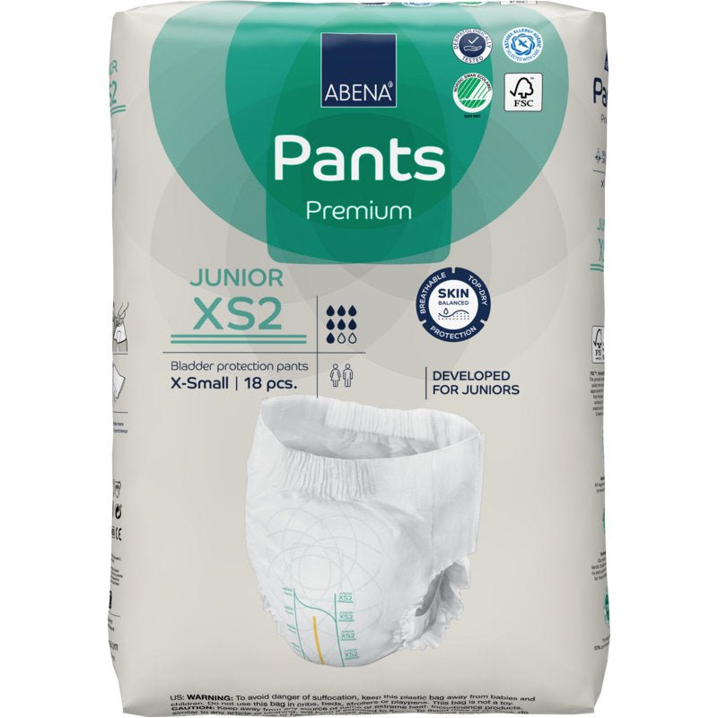 Balení ABENA Pants Junior Premium, vel. XS2 (18 kusů) od Abena Re-Seller GmbH nabízí ochranu proti úniku moči pro juniory. Obal ukazuje vlastnosti produktu, certifikační loga a obrázek pleny.