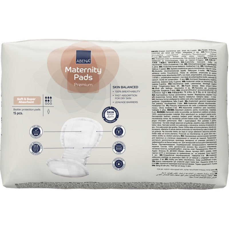 Zobrazeno je balení ABENA Maternity Pad, Premium (15 kusů) od Abena Re-Seller GmbH s vlastnostmi savosti, rovnováhy pokožky a ochrany proti úniku na vícejazyčném obalu.
