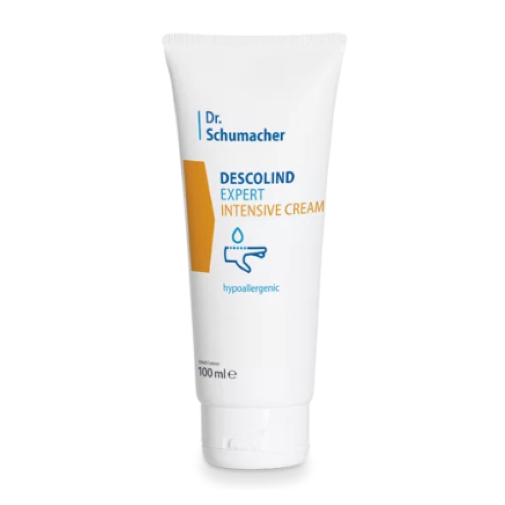 Bílá tuba s nápisem „Dr. Schumacher Descolind Expert Intensivcreme | Tube (100 ml)“ od společnosti Dr. Schumacher GmbH stojí vzpřímeně před jednoduchým pozadím. Obal obsahuje žlutý obdélník a symbol kapky a zdůrazňuje hypoalergenní vlastnosti, díky čemuž je ideální pro citlivou pokožku.