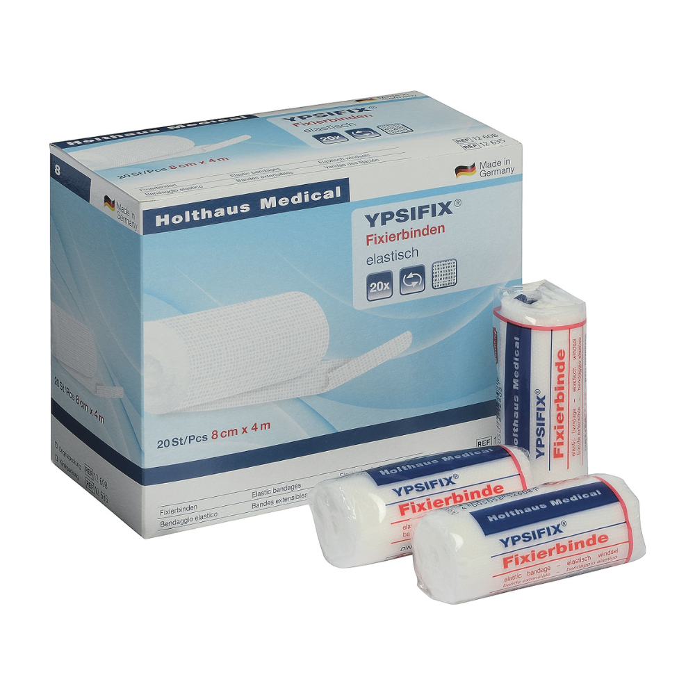 Obrázek krabice Holthaus Ypsifix® fixačního obvazu od Holthaus Medical GmbH & Co. KG, 8 cm x 4 m. Krabice obsahuje 20 jednotlivých obvazů. Na přední straně krabice jsou zobrazeny tři jednotlivé obvazy; dva jsou zatavené v plastu, zatímco jeden je částečně rozbalený. Vyrobeno v Německu, ideální pro fixaci obvazů na rány.