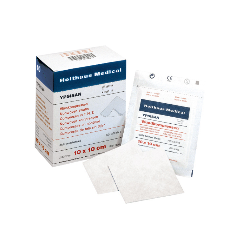 Na obrázku je krabička a balení Holthaus Ypsisan obvazových kompresí o rozměrech 10 x 10 cm. Krabička je otevřená, takže je vidět vnitřní obal. Před krabičkou jsou umístěny jednotlivé balení a několik obvazových kompresí, což je ideální pro komplexní ošetření ran. Výrobek je od společnosti Holthaus Medical GmbH & Co. KG a obsahuje 50 kusů (25 balení po 2 kusech).