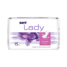 Die Seni Lady Super Inkontinenzeinlagen der TZMO Deutschland GmbH sind eine weiße Packung mit violetten Akzenten und floralen Motiven und enthalten 15 Einlagen bei mittlerer Blasenschwäche. Der deutsche Text enthält Hinweise zu Tragekomfort, Eigenschaften und Saugfähigkeit.